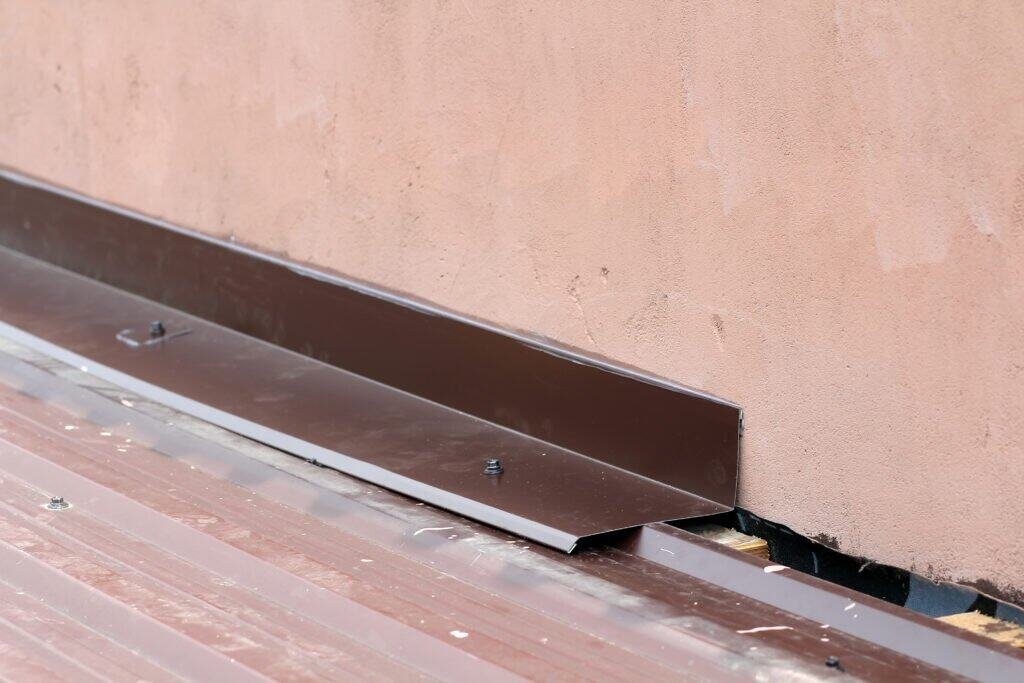 Metal flashing installed on building exterior to prevent water intrusion.