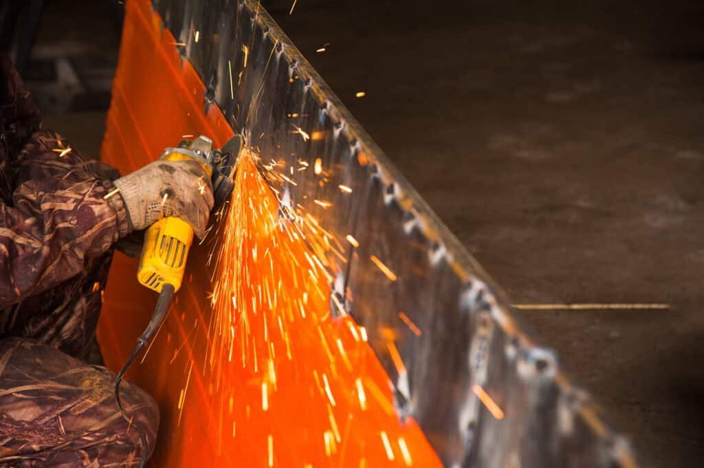 Hot metal fabrication and welding at LGL Sheet Metal Inc. with sparks flying during the industrial process.