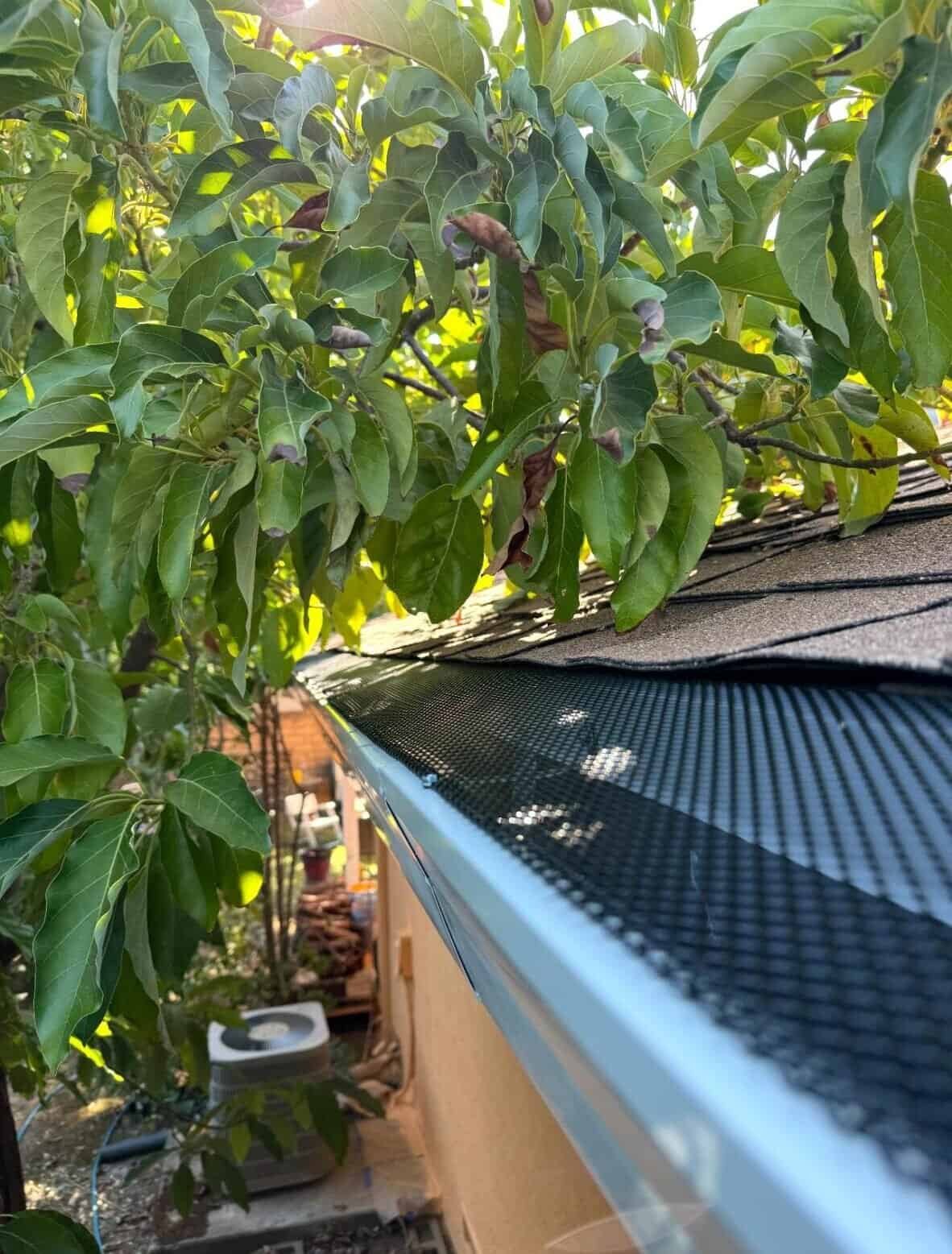 1. Aluminum gutter with leaf guard installed on a residential roof for gutter protection.