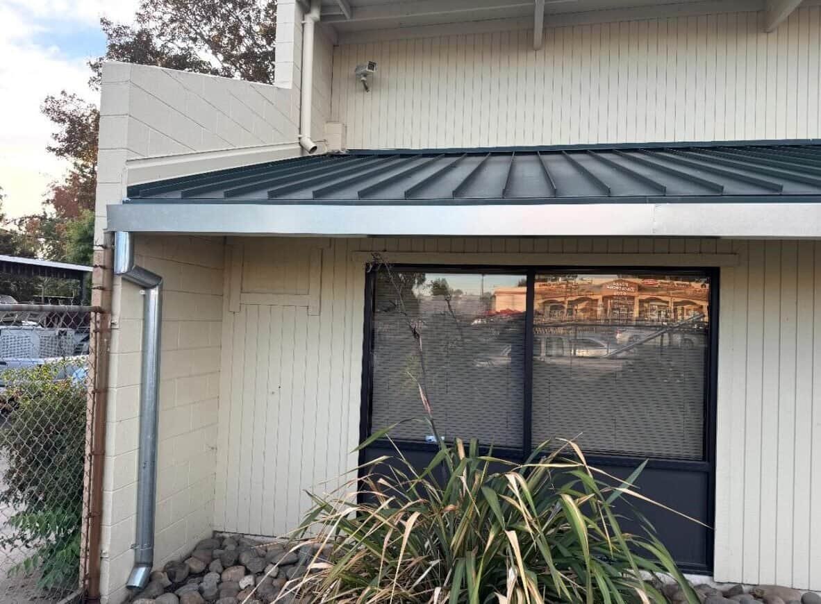 Custom metal awning installation by LGL Sheet Metal Inc. in residential building, durable and weather-resistant.