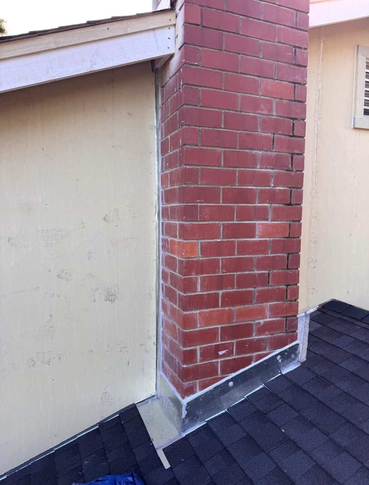 Seamless metal flashing around brick chimney and roofing, expert installation by LGL Sheet Metal Inc.