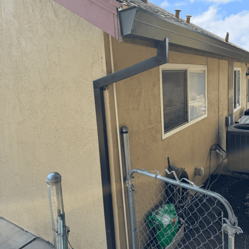 Flexible downspout extension attached to house gutter system.